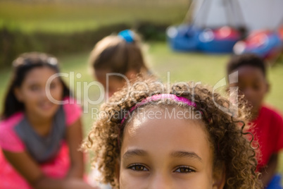 Cropped portrait of girl with friends in background