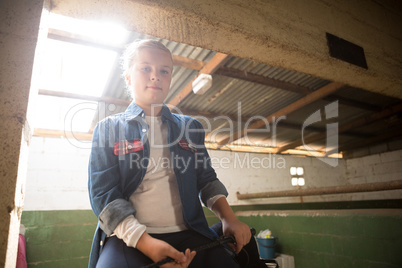 Girl sitting in stable