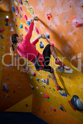 Determined woman practicing rock climbing