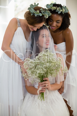 Bride interacting with bridesmaid at home