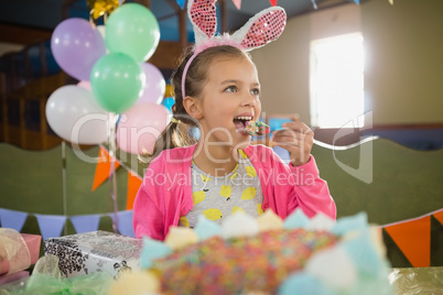 Birthday girl eating a cake