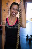 Woman preparing for rope climbing in fitness studio