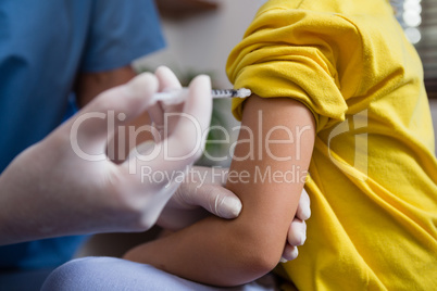 Physiotherapist injecting patient