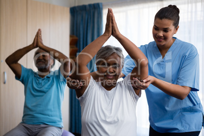 Nurse training seniors in exercising
