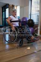 Portrait of smiling senior woman on wheelchair