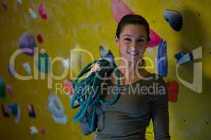 Happy woman with rope in fitness studio