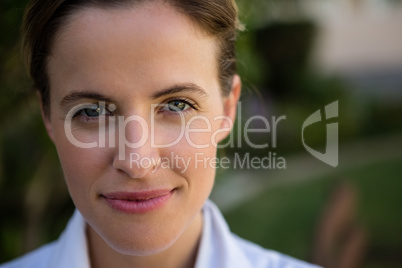 Portrait of confident female doctor in park