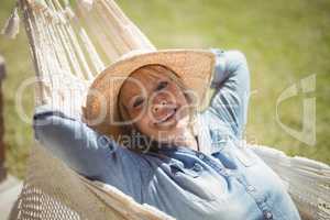 Smiling senior woman relaxing on hammock