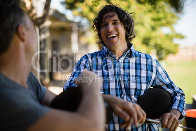 Two male friends interacting with each other in the ranch