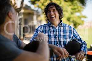 Two male friends interacting with each other in the ranch