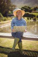 Smiling senior woman using laptop in park