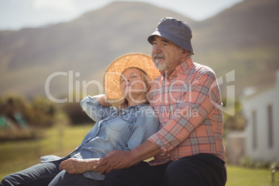 Senior couple relaxing together on bench