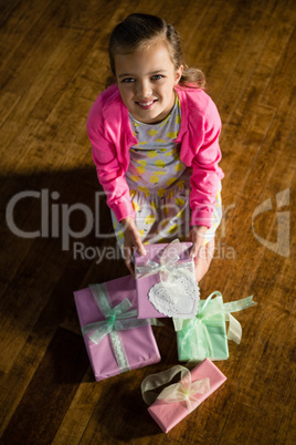 Girl with various gift boxes at home