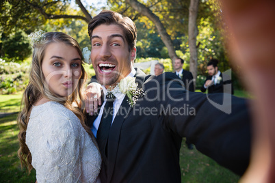 Portrait of happy couple posing in park