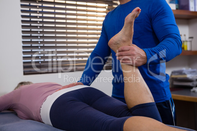 Physiotherapist giving leg massage to a woman