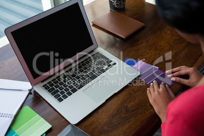 Cropped image of woman arranging color swatches