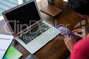 Cropped image of woman arranging color swatches