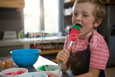 Boy holding green batter on spatula