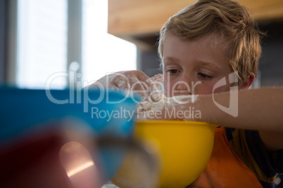 Boy preparing food in yellow container