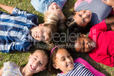 Overhead view of children lying on field