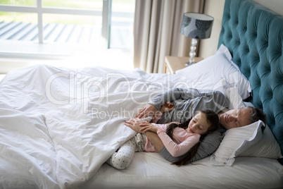 Father and daughter sleeping together on bed in bedroom Father and daughter sleeping together on bed in bedroom
