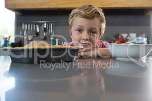 Portrait of boy at kitchen counter