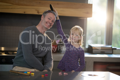 Daughter brushing fathers hair