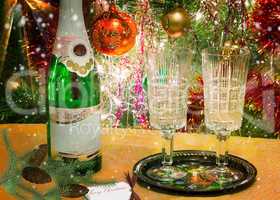 Christmas holiday, wine and glasses near a Christmas fir-tree.