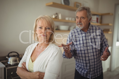 Senior couple arguing in kitchen