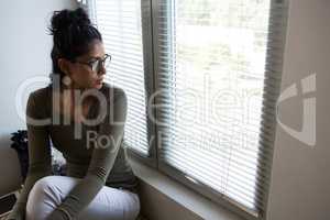 Thoughtful woman by window