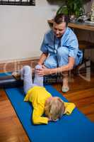 Physiotherapist giving physical therapy to the girl