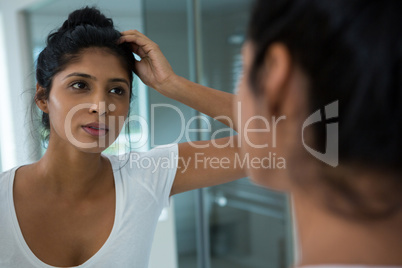 Pretty woman reflecting on mirror