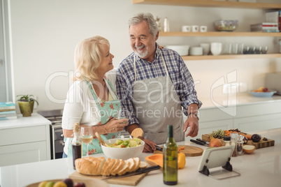 Senior couple preparing meal in kitchen Senior couple preparing meal in kitchen