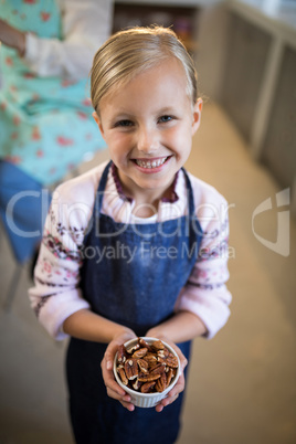 Little girl holding dry fruits in her hand