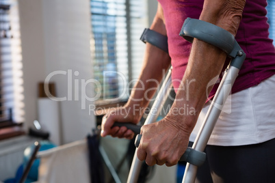 Mid-section of woman with crutches