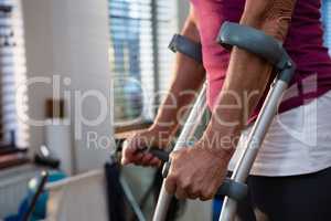 Mid-section of woman with crutches
