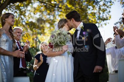 Affectionate man kissing woman in park