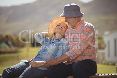 Smiling senior couple relaxing together on bench