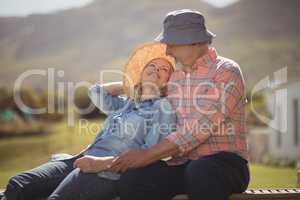 Smiling senior couple relaxing together on bench