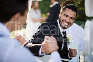 Man shaking hand with waiter during wedding