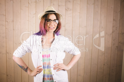 Girl in spectacles posing with hands on hip