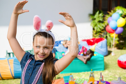 Portrait of smiling girl with arms raised