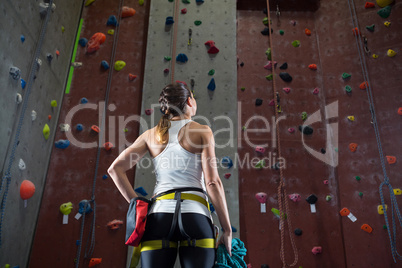 Woman standing with hands on hip in fitness studio