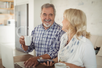 Senior couple using laptop