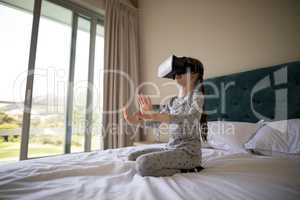 Girl using virtual reality headset on bed