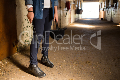 Girl standing in the stable