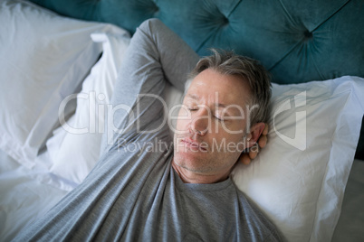 Man sleeping on bed in bedroom