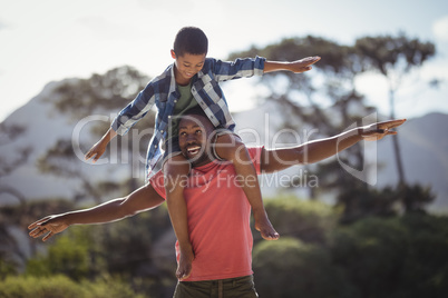 Father carrying son on shoulders