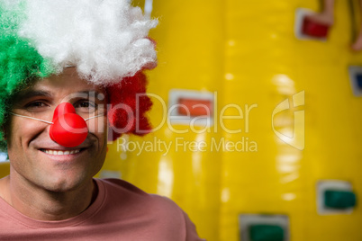 Portrait of man wearing clown nose