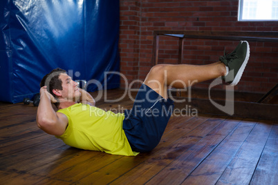 Determined man performing crunches